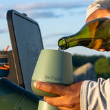 Pouring wine into tumbler while camping