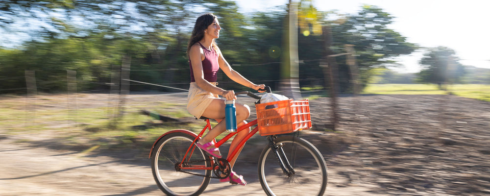 Woman on beach cruiser with water bottle