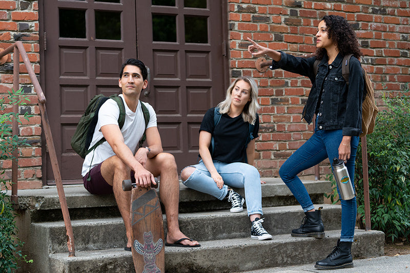 Three college students on campus with water bottle