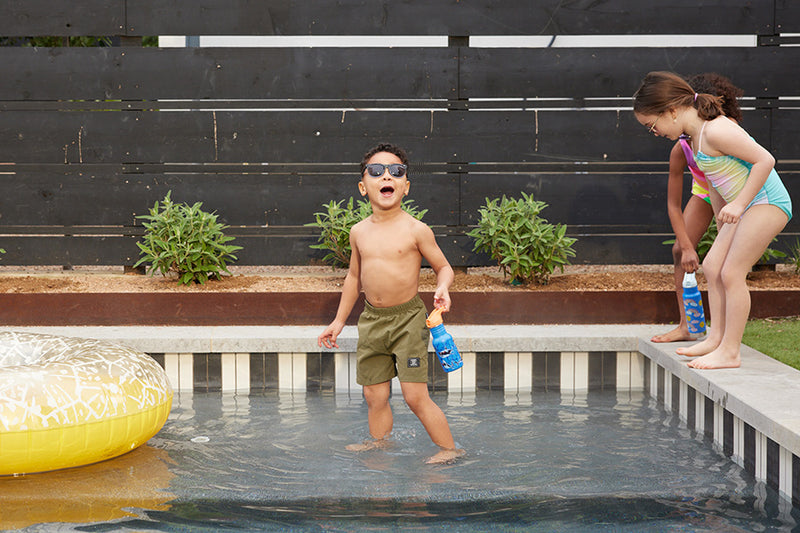 Kids in pool with water bottles