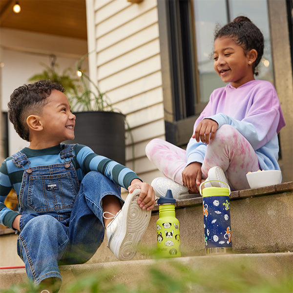 Kids on steps with sippy water bottles